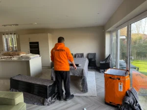 Worker packing boxes for eco-friendly moving Manchester, using sustainable materials.