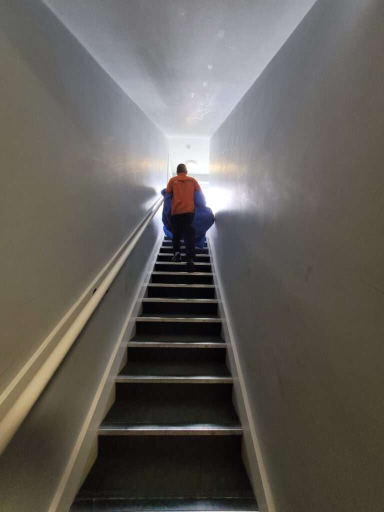 A person on the phone looking concerned while reviewing a suspicious-looking quote, highlighting the importance of spotting Manchester rogue movers.