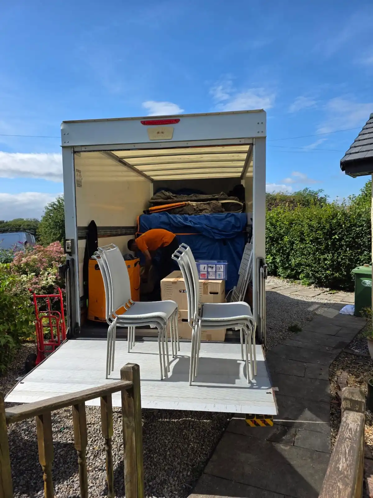 A Metro Man and van Luton van, showing professionally protected furniture (like the blue-wrapped item) and a safe tail lift, ready for a Manchester autumn move.