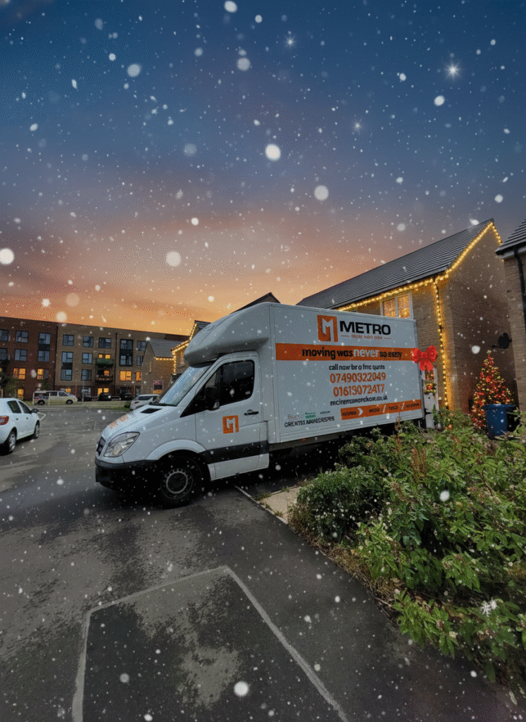 The Metro Man and van, decorated with a red bow, completing a perfect Manchester Christmas move at twilight